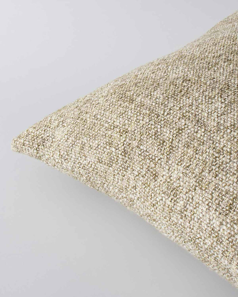 Corner view of a textural woven cushion in shades of creamy oat and ercu, by Baya