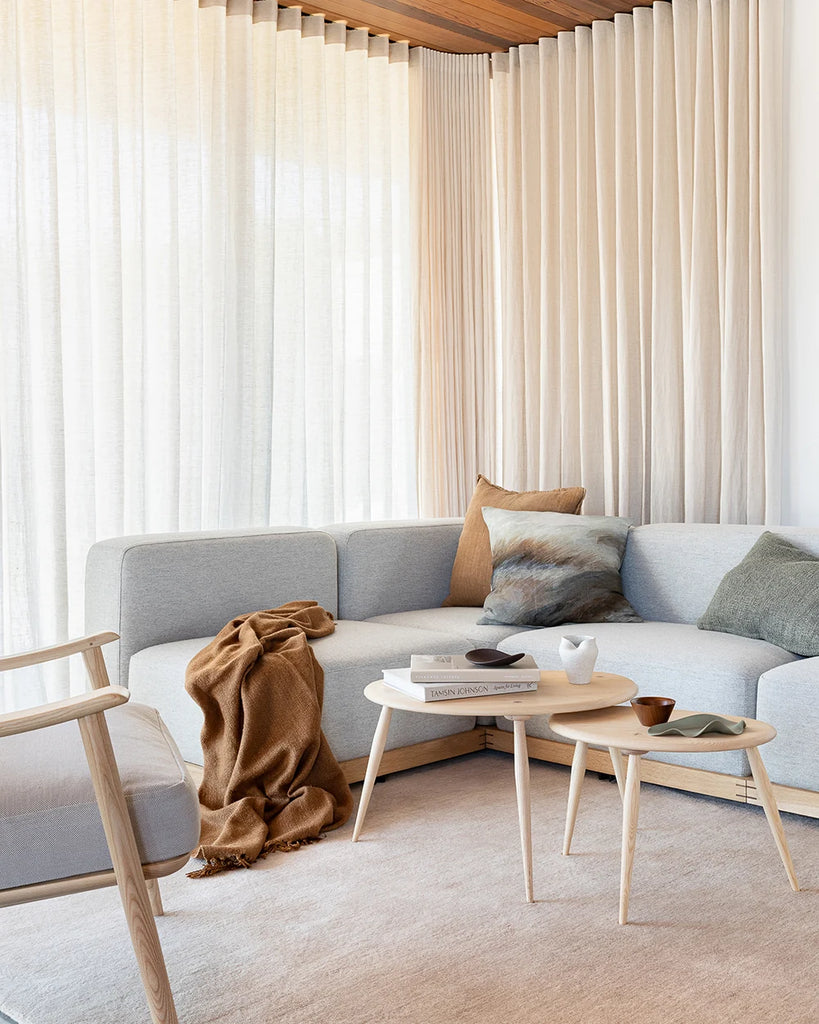 The Baya Dune cushions and Cassia Cumin cushion on a couch in a modern living room