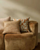 A selection of decorative cushions by Weave Home nz, seen on a tan brown velvet couch