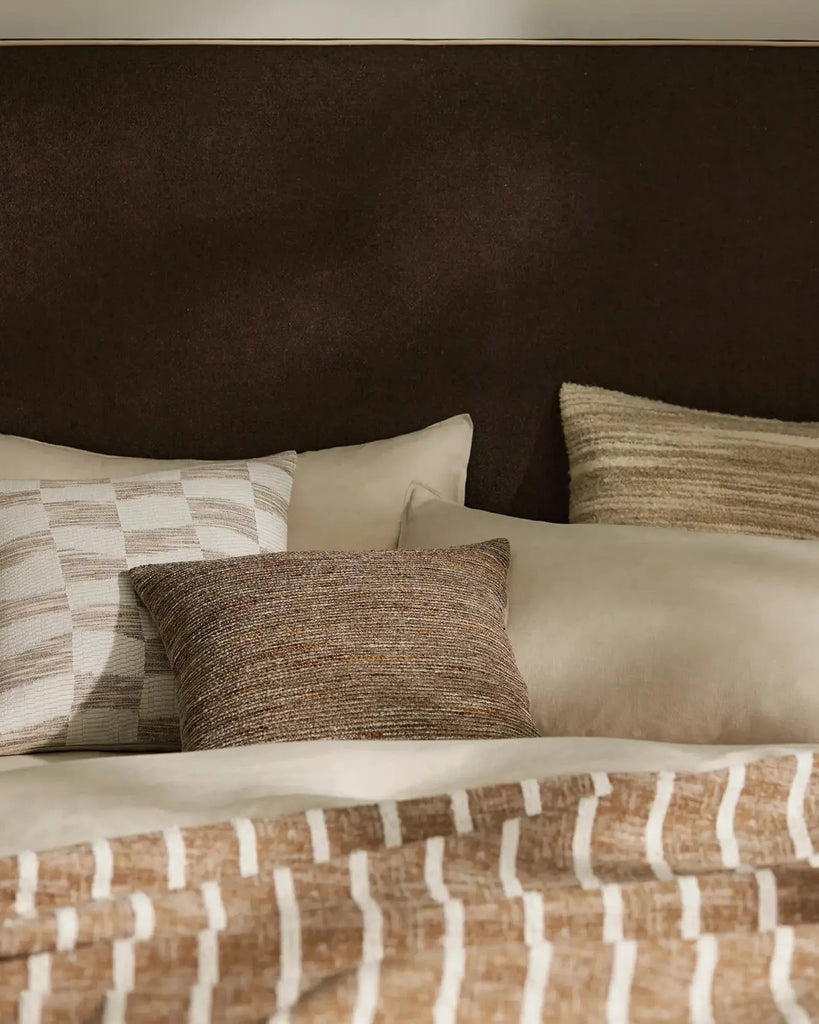 A stylish bedroom setting featuring brown-toned cushions by Weave Home nz