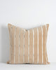 A soft velvety textural cushion with stripes in shades of soft light brown and beige. By Baya