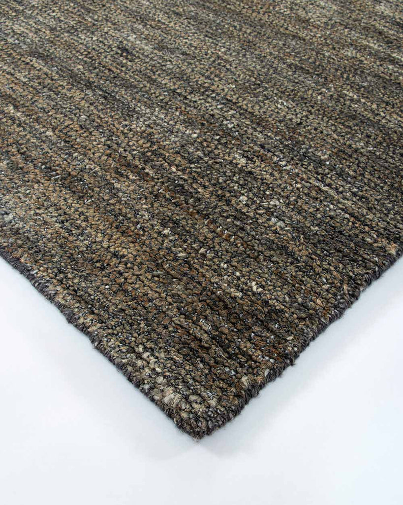 A corner image of the Fairbanks floor rug by Baya, handwoven and effortlessly chic. 