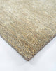 A corner image of the Baya Fairbanks floor rug in Limestone, a soft beige. The weave of the rug catches the light beautifully. 