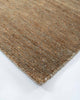 A corner image of the Fairbanks floor rug in shade Sand, a deliciously warm toned brown handwoven piece. 