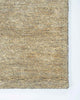 A corner image of the Baya Fairbanks floor rug in Limestone, a soft beige. The weave of the rug catches the light beautifully. 