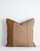 A textural linen cushion with an asymmetric pattern in shades of warm brown with fringing all the way around. By Baya