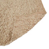 Close up of the corner of a textural wool blend boucle style rug by Globe West and Soren Liv NZ in shades of warm beige and light brown, with the edge flipped up to show the underside. 