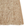Close up of the corner of a textural wool blend boucle style rug by Globe West and Soren Liv NZ in shades of warm beige and light brown, with indented edges