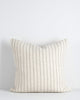 A handwoven wool cushion in shades of cream with navy vertical stripes. By Baya