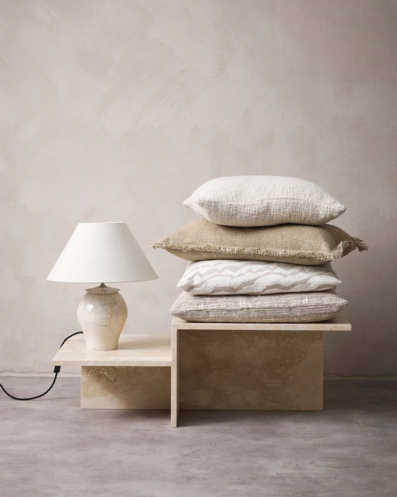 A stack of neutral and beige coloured cushions by Baya nz