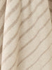 Close up of the stripe in the NZ merino wool throw blanket featuring a cream and beige stripe design