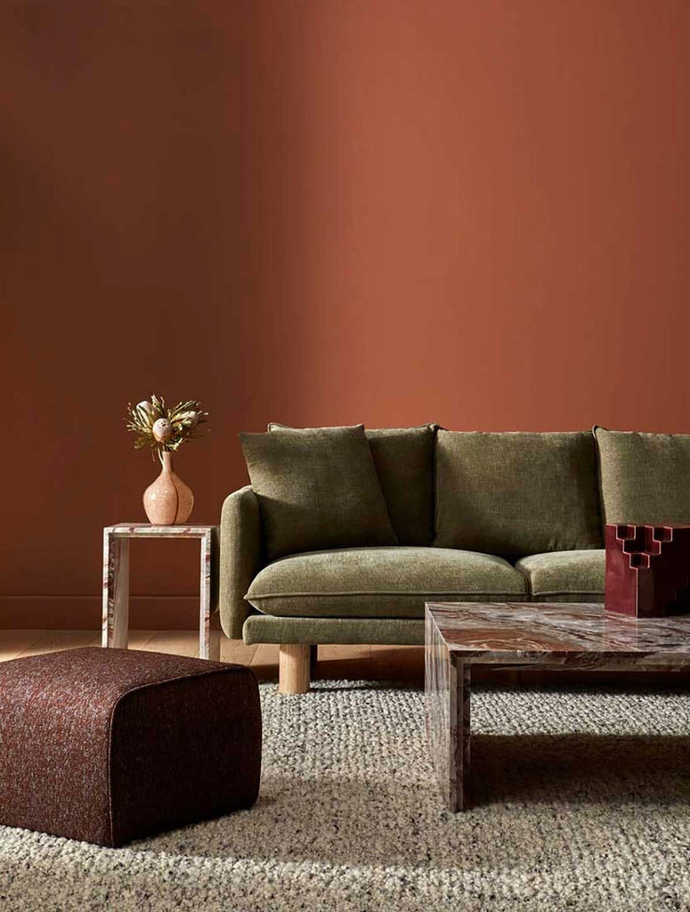 A textural wool blend boucle style rug by Globe West and Soren Liv NZ in shades of light grey and brown, situated in a stylish living room. 