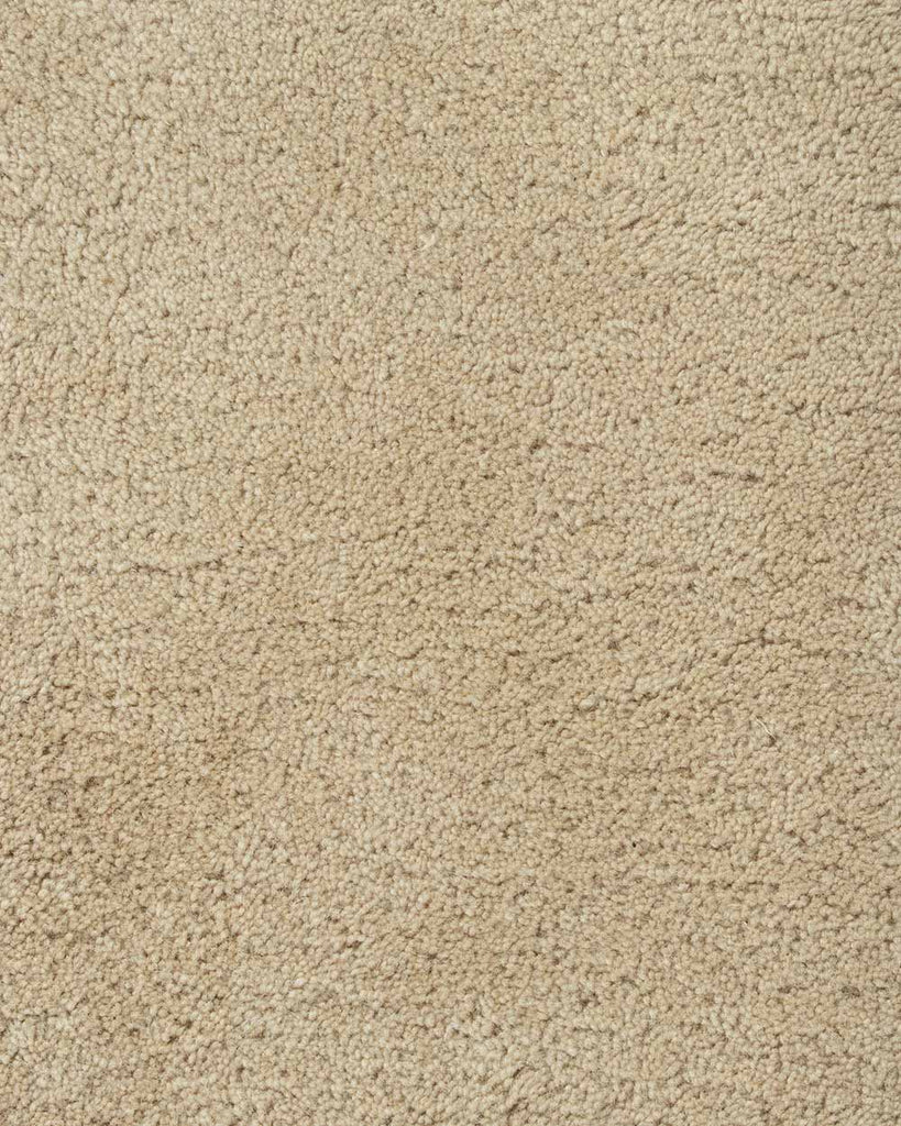 A close up of the weave of the Norfolk floor rug in Sand. The luxurious depth of the pile and sumptuous warm beige colour make this rug a standout. 