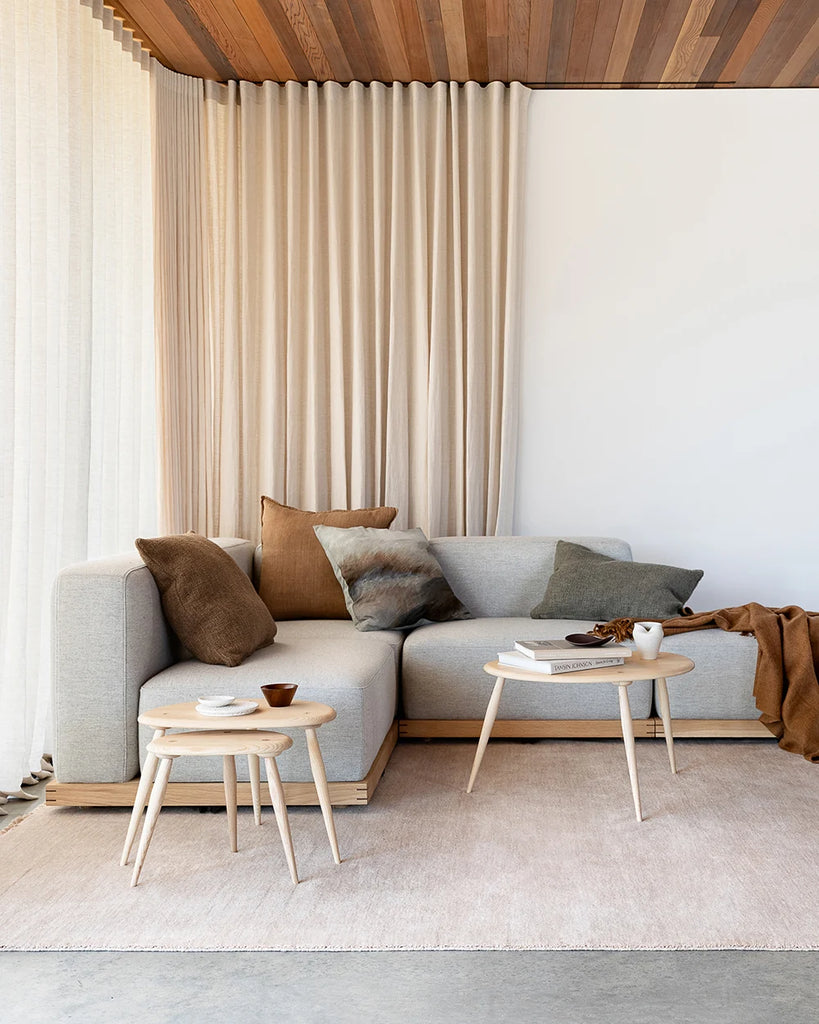 Brown and green Baya cushions on a couch in a stylish nz home