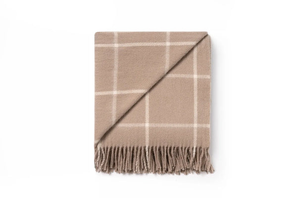 A nz wool throw blanket in a neutral light brown, woven in a simple check, by Ruanui Station