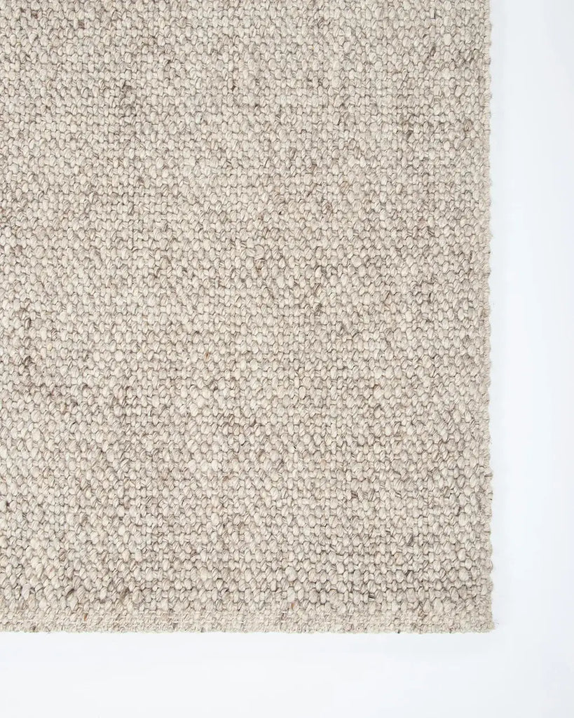Corner from above of the Baya woven textural floor rug 'Omaha' in colour 'Pebble' 