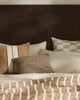 Brown and cream cushions by Weave Home nz, on a bed in a stylish bedroom