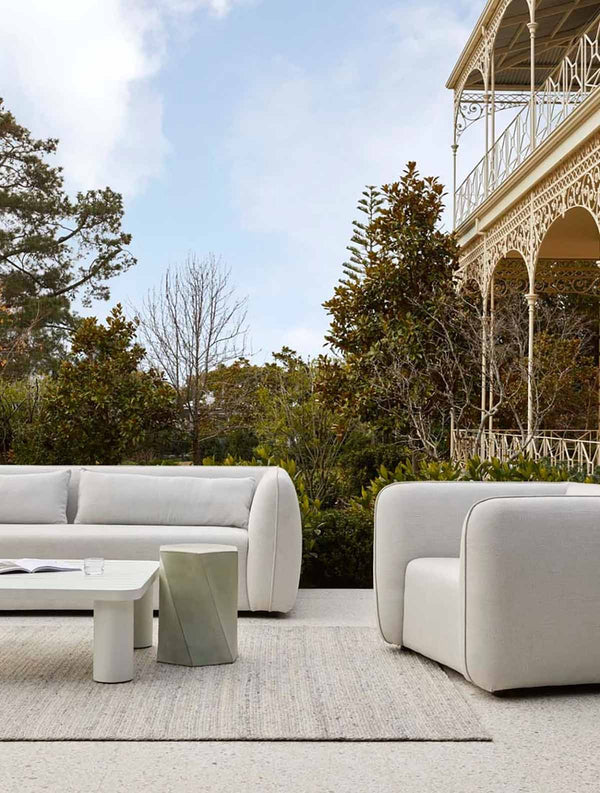 A handknotted rug by Globe West and Soren Liv NZ in neutral grey beige tones, perfect for outdoors or transition spaces, placed in a stylish outdoor space.