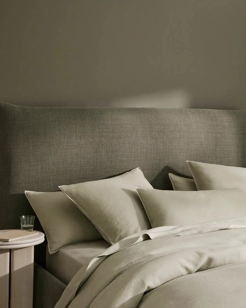 Weave Home Ravello premium French flax linen bedding displayed on a bed in a stylish room 