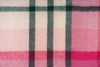 A close up of the pattern of the pink, green and cream check of the throw blanket by Ruanui Station, NZ. 