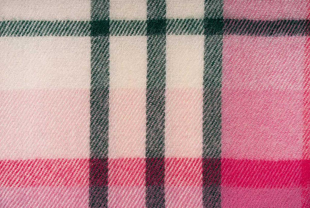 A close up of the pattern of the pink, green and cream check of the throw blanket by Ruanui Station, NZ. 