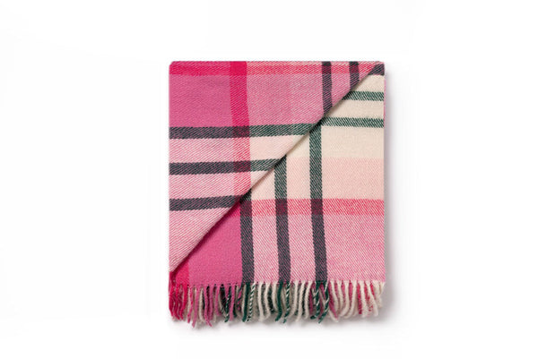 A folded pink and green check throw blanket by Ruanui Station, NZ. It is folded back on itself to show the differentiation in pattern. 