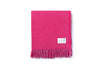 A folded bright pink throw blanket by Ruanui Station, NZ