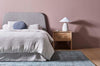 A beautiful soft viscose blend statement rug in shades of muted ocean blue, by Globe West and Soren Liv NZ, situated in a modern bedroom.