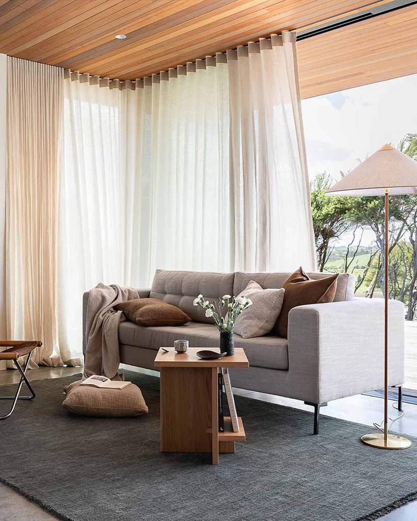 A cool green forest toned floor rug in 100% wool in a neutral toned living room. 