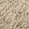 Close up of the weave of a textural wool blend boucle style rug by Globe West and Soren Liv NZ in shades of light grey and brown.