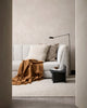 Brown throw blanket in colour 'cinnamon' draped on a couch in a modern living room