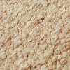 Close up of the weave of a textural wool blend boucle style rug by Globe West and Soren Liv NZ in shades of warm beige and light brown.