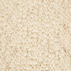 Close up of the weave of a textural wool blend boucle style rug by Globe West and Soren Liv NZ in shades of warm ivory and cream. 