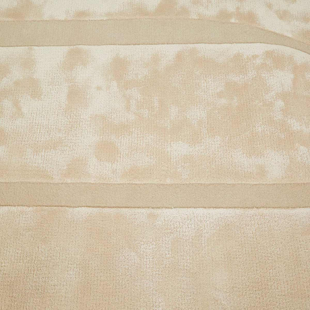 Detailed view showing the weave of a cream, light natural beige floor rug with geometric designs rendered in alternating pile heights, by Globe West and Soren Liv NZ.