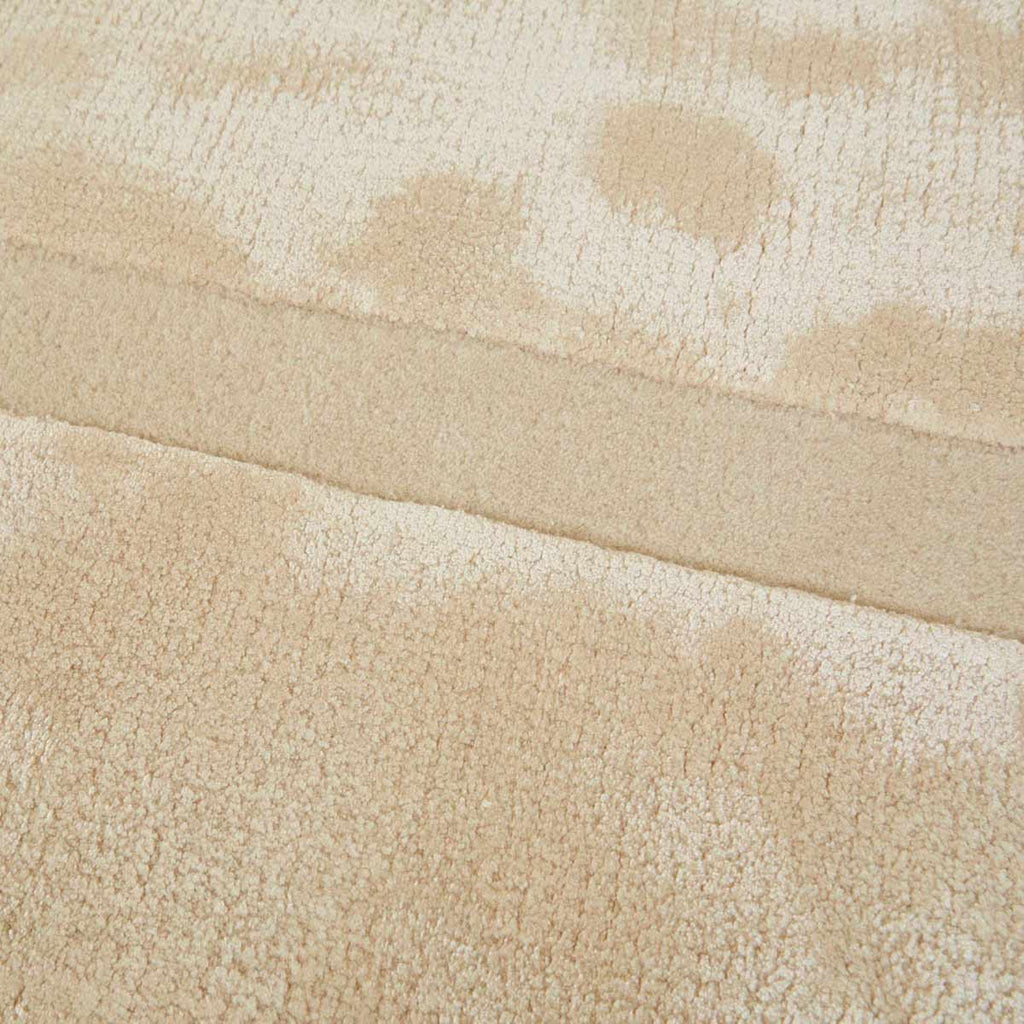 Detailed view showing the weave of a cream, light natural beige floor rug with geometric designs rendered in alternating pile heights, by Globe West and Soren Liv NZ.