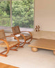 Two wicker chairs and a coffee table in a modern living room, tied together with a sophisticated light rug by Baya NZ